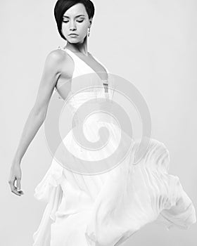 Beautiful young lady in a billowing white dress