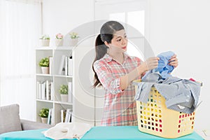 Beautiful young lady doing housekeeping at home