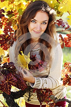 Beautiful young lady in grape vineyard