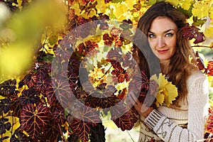 Beautiful young lady in grape vineyard
