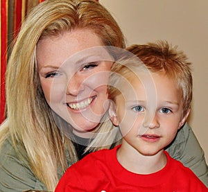 Beautiful Young lady holding cute boy smiling