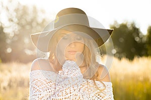 Beautiful young lady model posing in a field at sunrise - outdoors shoot