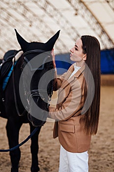 Beautiful young lady portrait lifestyle. Pretty woman posing with horse.