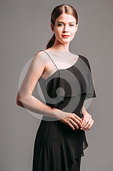 Beautiful young lady posing in studio. Elegant female fashion, summer festive look photo