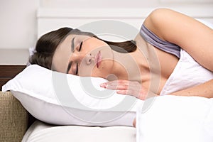 Beautiful young lady sleeping in bed.