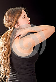 Beautiful young lady Suffer crick after workout in a black background
