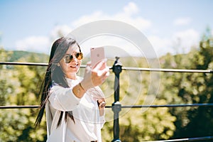 Beautiful young lady taking a selfie