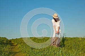 Beautiful young lady travelling with a suitcase