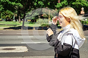 Beautiful young Latin woman in a white shirt crossing the street