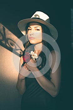 Beautiful young latino woman with panama hat portrait