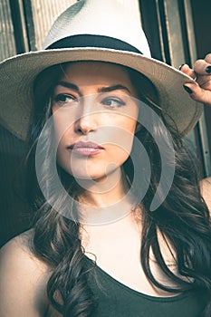 Beautiful young latino woman with panama hat portrait outdoor in