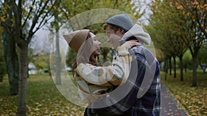 Beautiful young lovers kissing romantically in autumn park. Close up of couple.