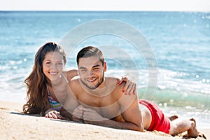 Beautiful young lovers sunbathing