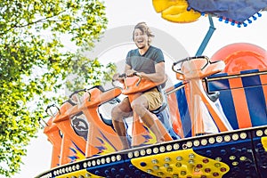 Beautiful, young man having fun at an amusement park