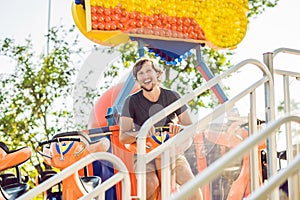 Beautiful, young man having fun at an amusement park