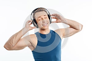Beautiful young man is relaxing with earphones