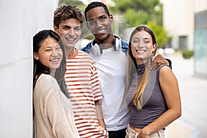 Beautiful young men and women smiling and looking at camera.Diverse group of joyful millennial people staring happy at