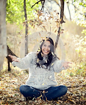 Beautiful Young Millennial Hispanic, American Indian, Multi-racial Woman Throwing Leaves