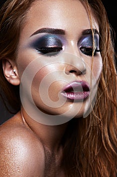 Beautiful young model with bright make-up. Blue eyeshadow