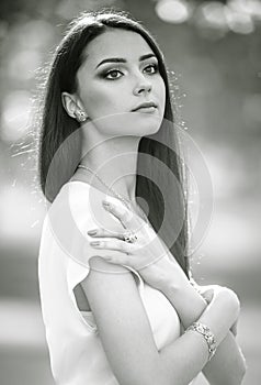 Beautiful young model with long hair and stylish jewelry and accessory. Black and white photography