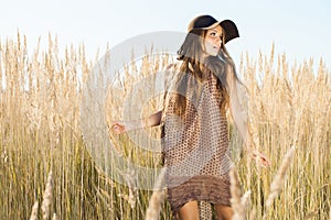 Beautiful young model passing tallgrass meadow photo