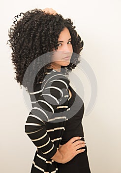 Beautiful Young Model Posing with Big Black Curly Hair. photo