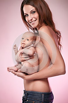 Beautiful young mom holding a baby (retouched)