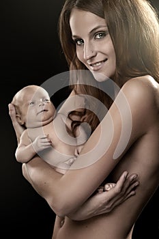 Beautiful young mom holding a baby (retouched)