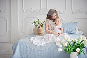 beautiful young mother with baby girl in her arms. The concept of a happy family, motherhood. mother playing with her baby in the