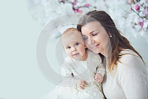 beautiful young mother with a baby in her arms is standing The concept of a happy family, motherhood