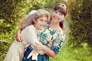 Beautiful young mother in a floral dress and daughter teen 10 ye