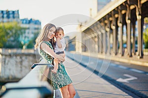 Beautiful young mother with her son in Paris