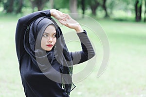 Beautiful young muslim asian woman doing exercise before running.