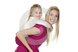 Beautiful Young Nanny Giving a Little Girl a Piggy Back Ride photo
