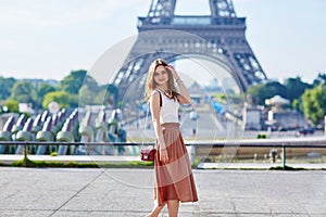 Beautiful young Parisian woman near the Eiffel tower