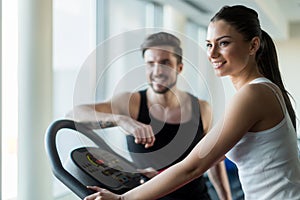 Beautiful, young people talking in a gym while working out