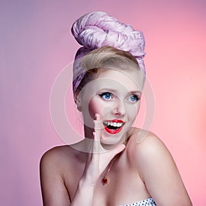 Beautiful young pin-up girl with surprised expression, on white background