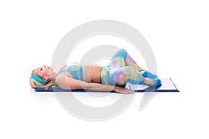 Beautiful young pregnant woman doing exercises on a white background. Early pregnancy