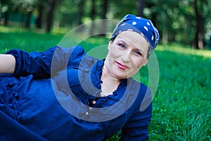 Beautiful young pregnant woman in nature couched