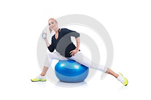 Beautiful young pregnant woman posing with blue pilates ball on a white background. Early pregnancy