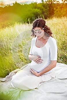 Beautiful young pregnant woman retouched