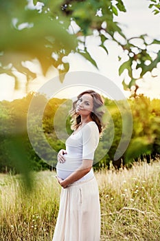 Beautiful young pregnant woman retouched