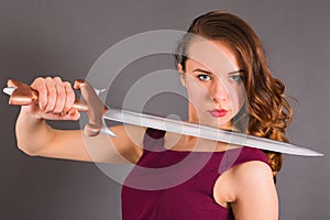 Beautiful young pure princess girl with a sword