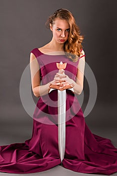 Beautiful young pure princess girl in long dress with a sword, k