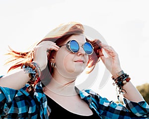 Beautiful young red hair woman sunglasses photo