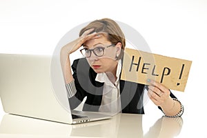 Attractive young overwhelmed and frustrated business woman working on her computer asking for help photo