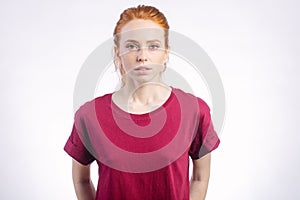 Beautiful young redhead girl with clean fresh face and neutral emotions close up photo