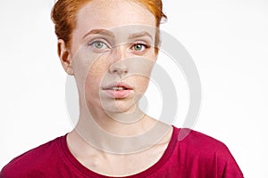 Beautiful young redhead girl with clean fresh face and neutral emotions close up