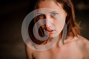 Beautiful young redhead girl in the water cave