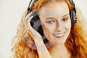 Beautiful young redhead with headphones